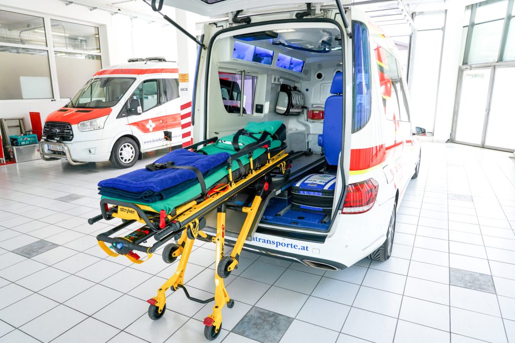Interior view of an ambulance with stretcher and medical equipment.