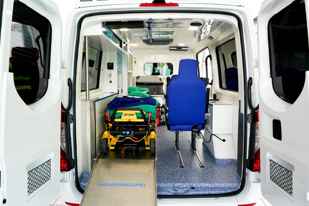 Modern ambulance with stair chair and blue seat for comfortable non-emergency medical transports.